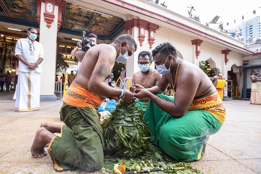 Practitioners preparing the core of the Karagam with neem leaves. Credits: Hindu Endowments Board.