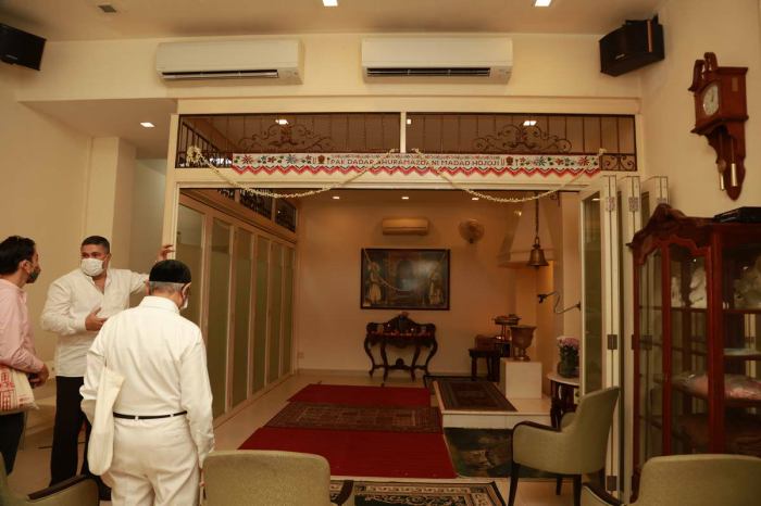 Mr Rustom Ghadiali in front of the prayer area at the Zoroastrian House, Singapore, where candles are kept lit to symbolize the fire typically found in fire temples.