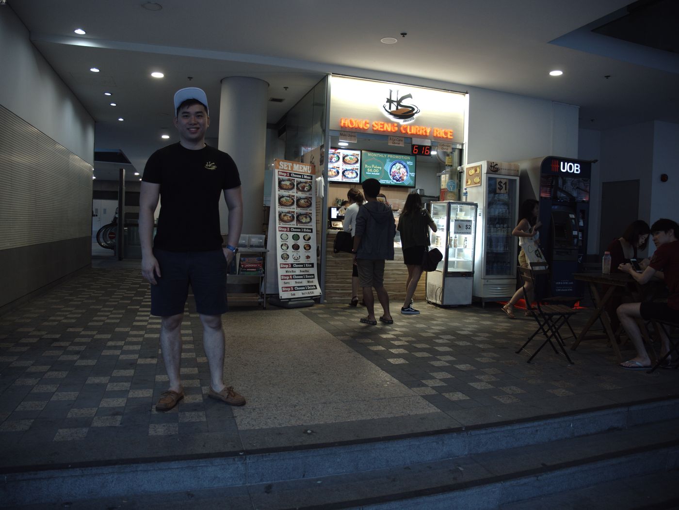 Mr Lim Jia Han, owner of Hong Seng Curry Rice, in front of his stall at Singapore Management University. 