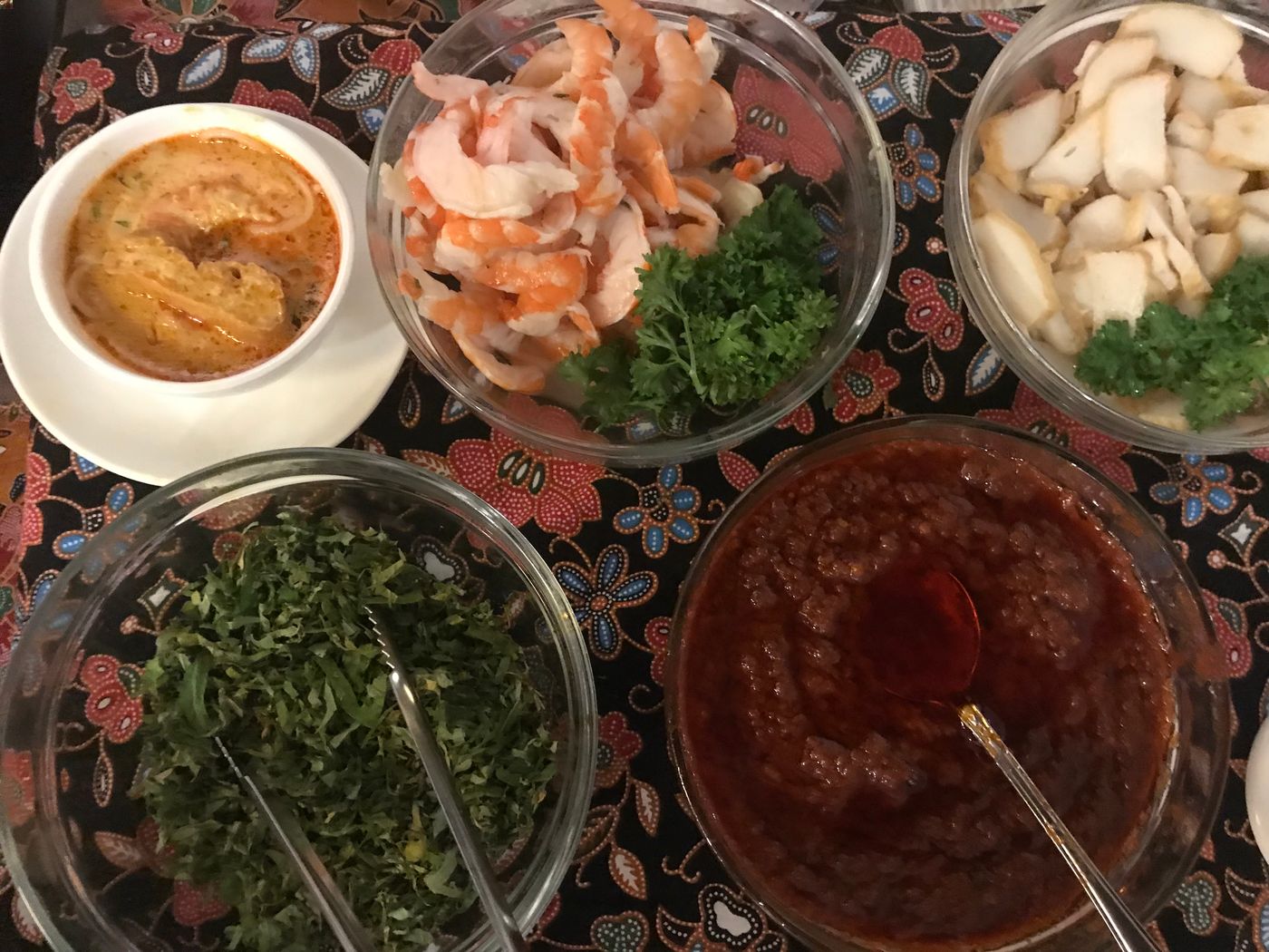 Ingredients for laksa include prawns, fishcake, sambal chilli and laksa leaves.