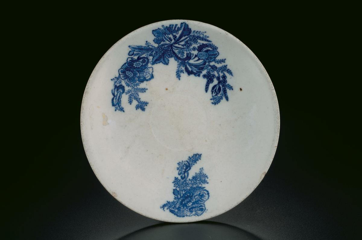 White porcelain saucer with blue floral motif