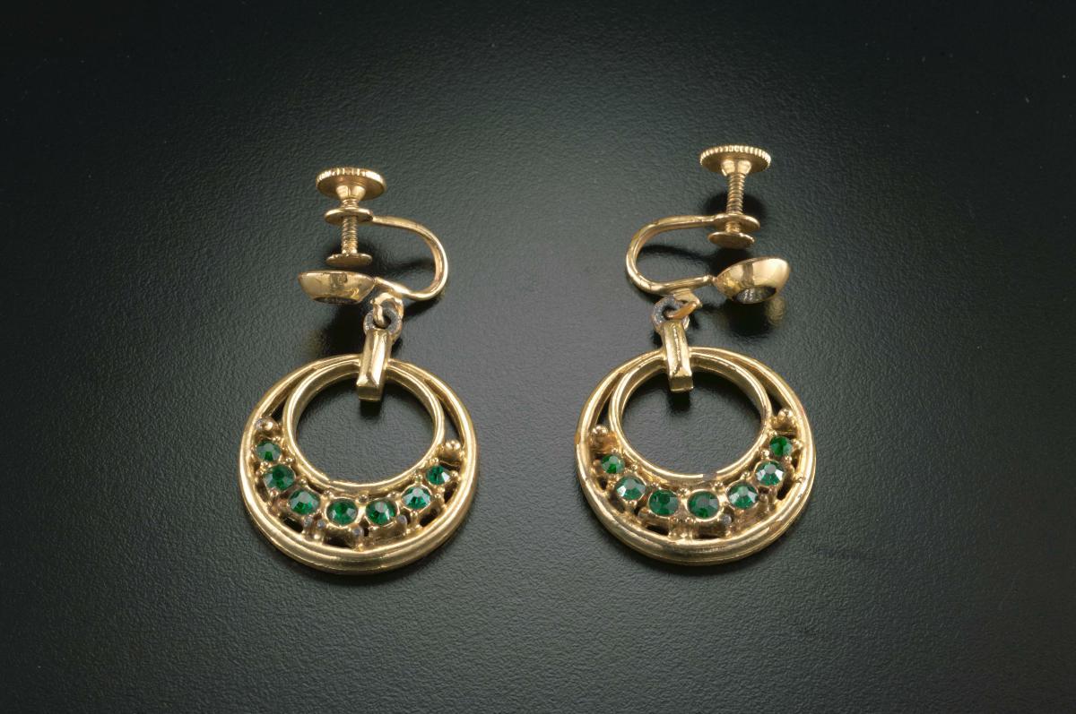 A pair of clip-on ear rings with green diamanté that belonged to a ...