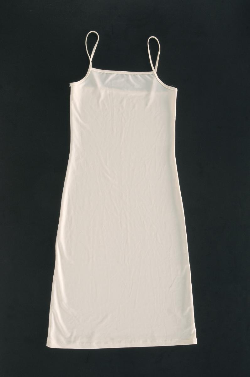 A white slip for a brown Akira Isogawa sleeveless dress with leaf motifs