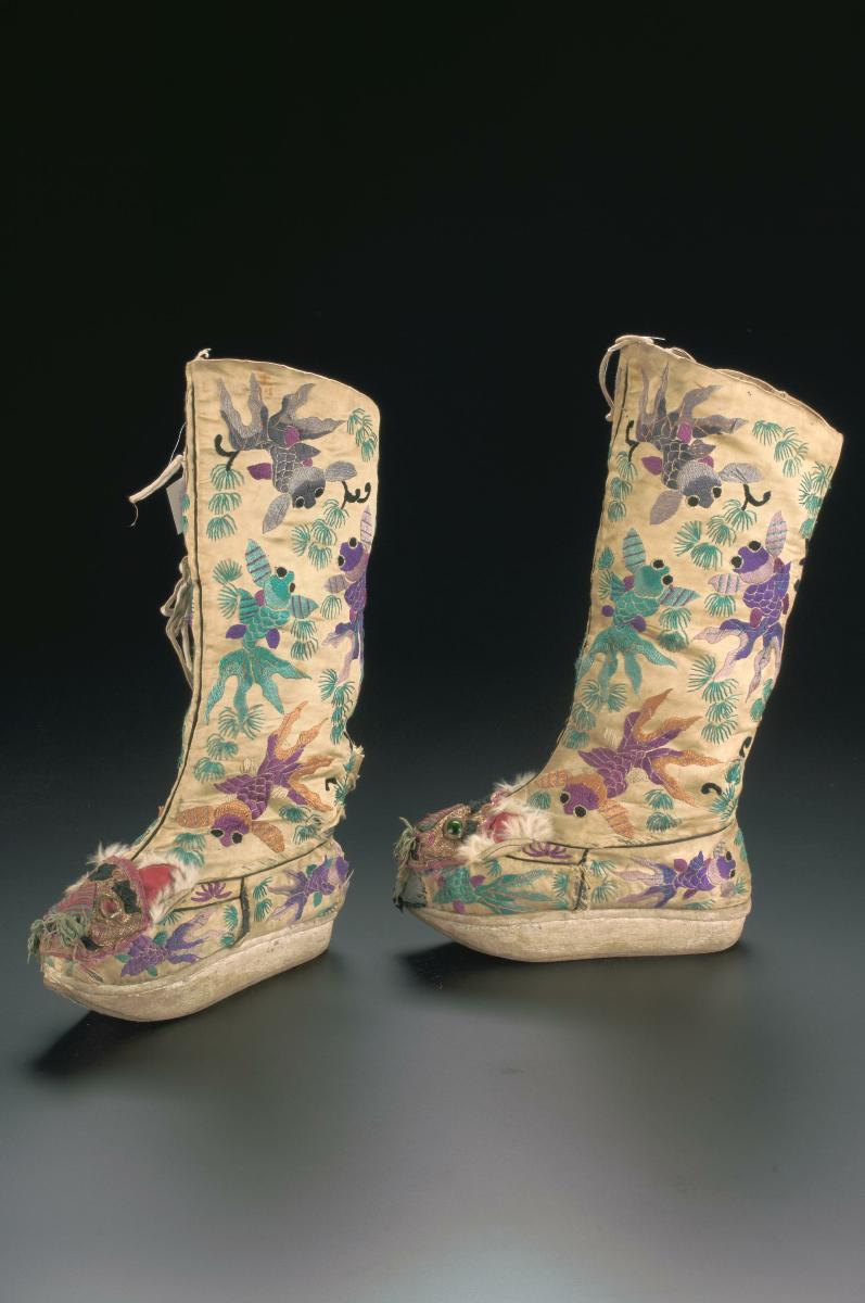 A platform boot with embroidered goldfish motifs worn in a Chinese ...