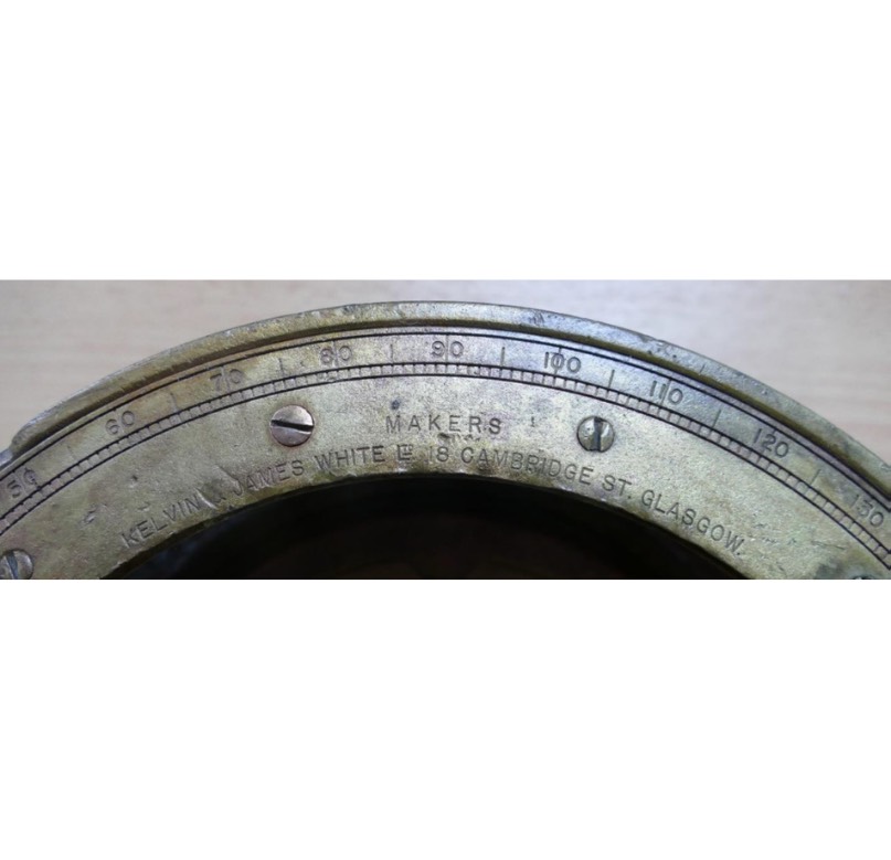 <em>Brass compass with makers’ mark.</em>