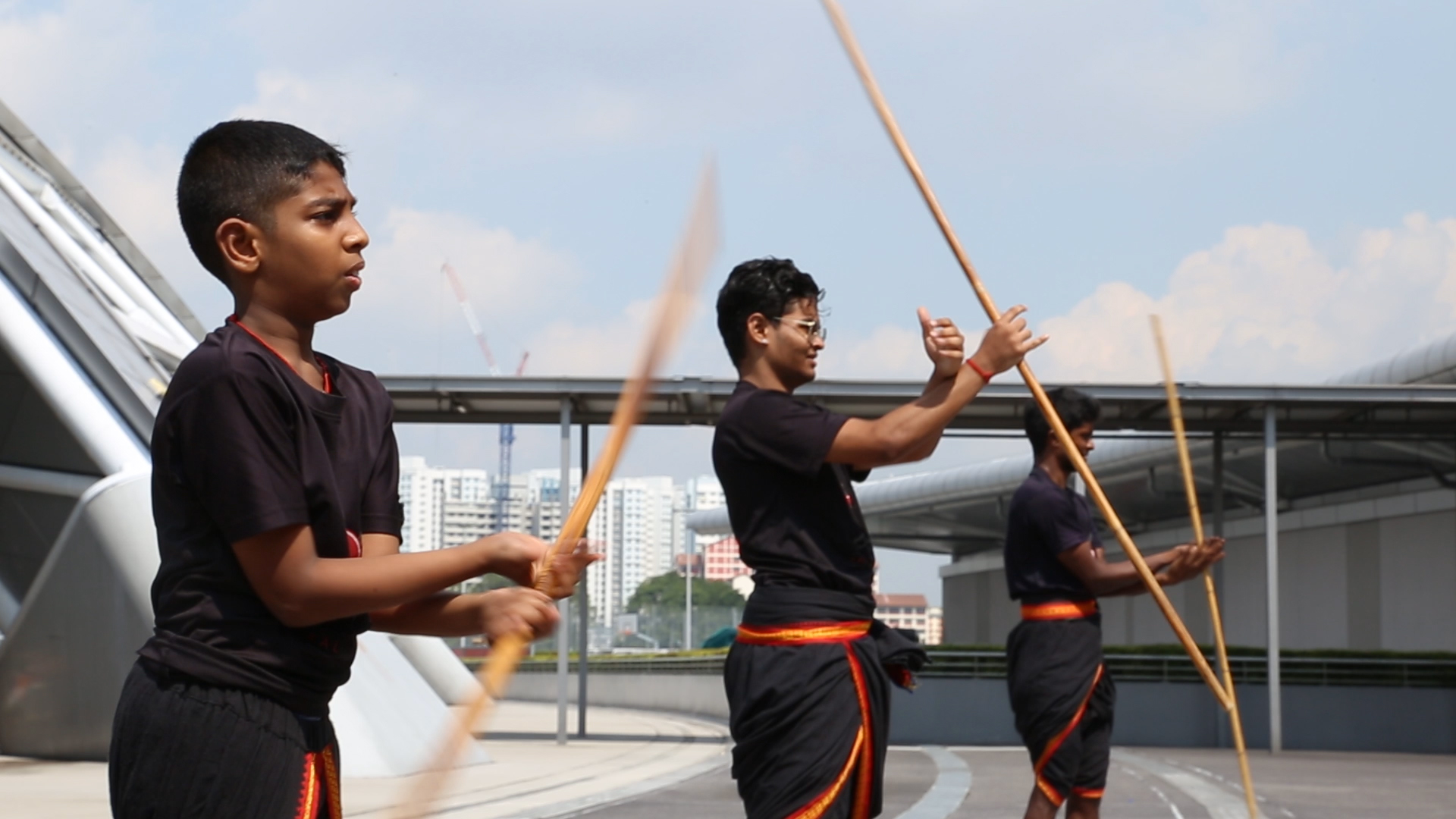 Students at The Kalari Academy practising hand movements with the silambam staff