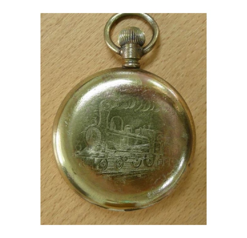 <em>Brass pocket watch – with a steam locomotive engraved on the back.</em>