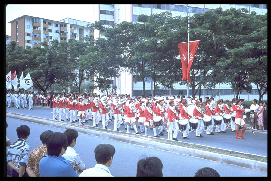 <strong>Photograph of a school band participating in a 5-km route march as part of the National Day Parade held at Jurong Stadium in 1977<br>
</strong>Reproduction<br>
9 August 1977<br>
Ministry of Information and the Arts Collection
<br>
Courtesy of the National Archives of Singapore